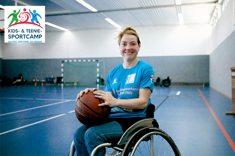 
        Athletin im Rollstuhl mit Basketball in den Händen in Sporthalle.
    